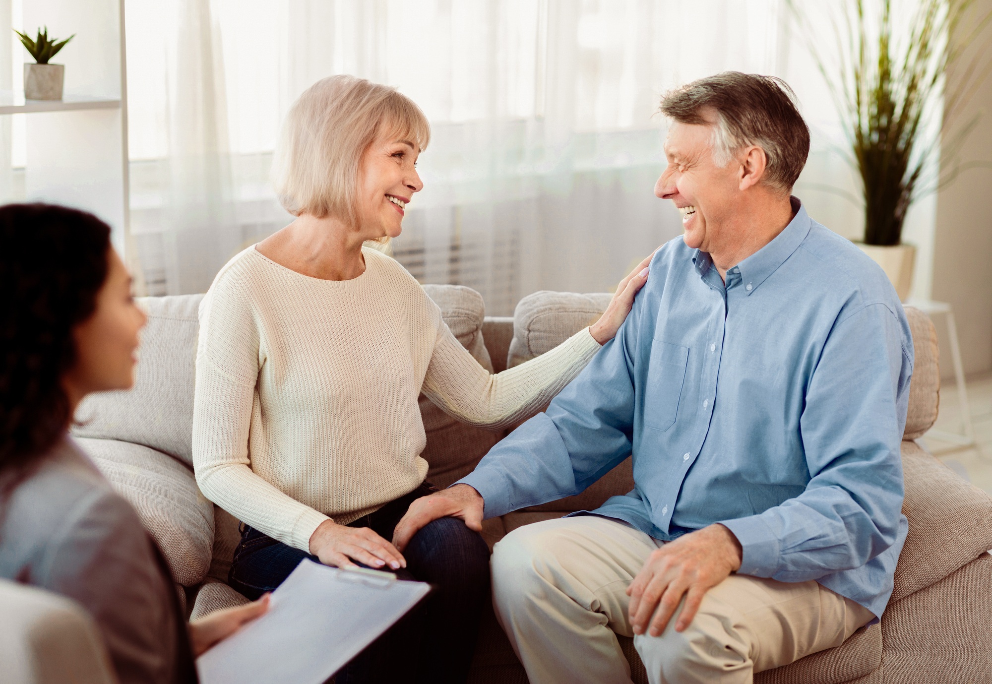 Happy mature couple laughing during successful therapy